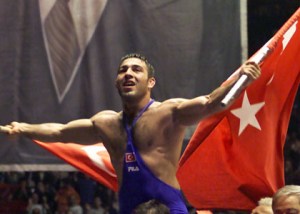 Turkey's Hamza Yerlikaya waves Turkish flags in front of a huge poster of Mustafa Kemal Ataturk in Istanbul on Sunday, May 13, 2001 after the European Greco-Roman Wrestling Championship 85 kg final. Hamza Yerlikaya of Turkey won the gold medal by defeating Marcin Letki of Poland. Mustafa Kemal Ataturk is the founder of the Turkish Republic. (AP Photo/Murad Sezer)